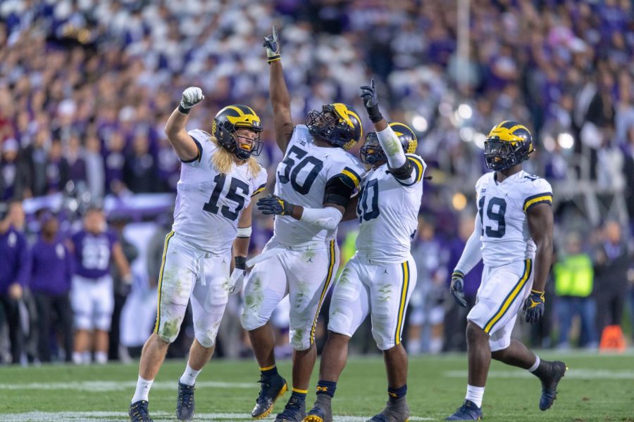 The Michigan Wolverines defense celebrates a come from behind win at Northwestern