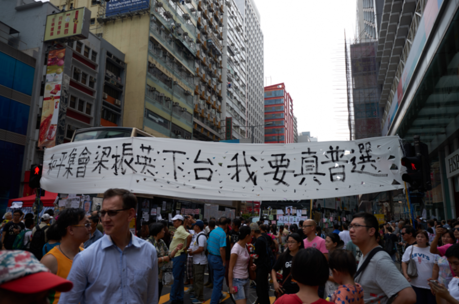 Hong Kong protesters on the streets. The banner reads,"Peaceful gathering, CY Leung steps down, I want true universal suffrage."