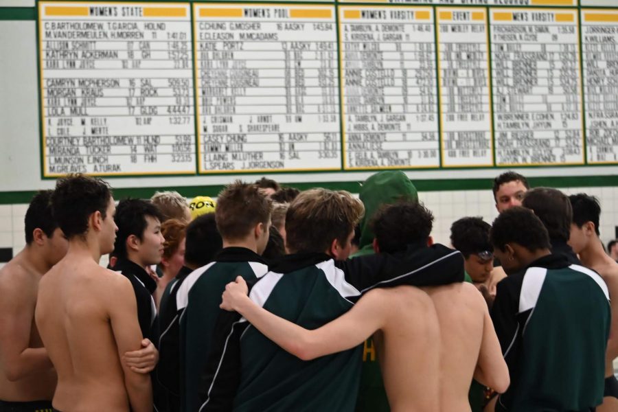 Senior Dylan Schmitzerle and Junior Eli Atkinson share a warm embrace during Hurons Tri-Meet against Lincoln and Adrian