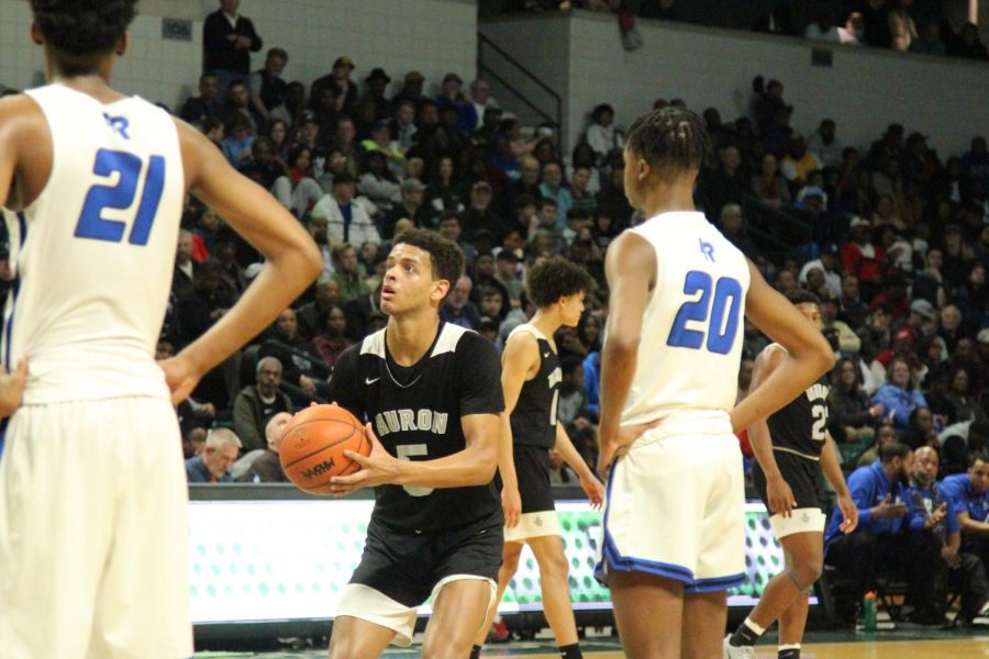 Junior Julian Lewis (five) shoots free throws after technical foul called on Lincoln.