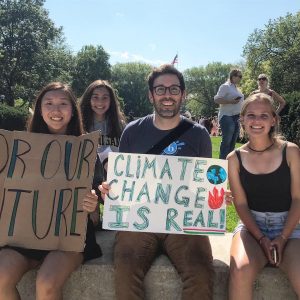 (Left to right) Senior Jasmine Xu, junior Verena Wu, English teacher Mr. Erickson and Junior Rita Seidl protest against climate change in downtown Ann Arbor. Wu often organizes and promotes events like this to the green team and encourages them to participate. 