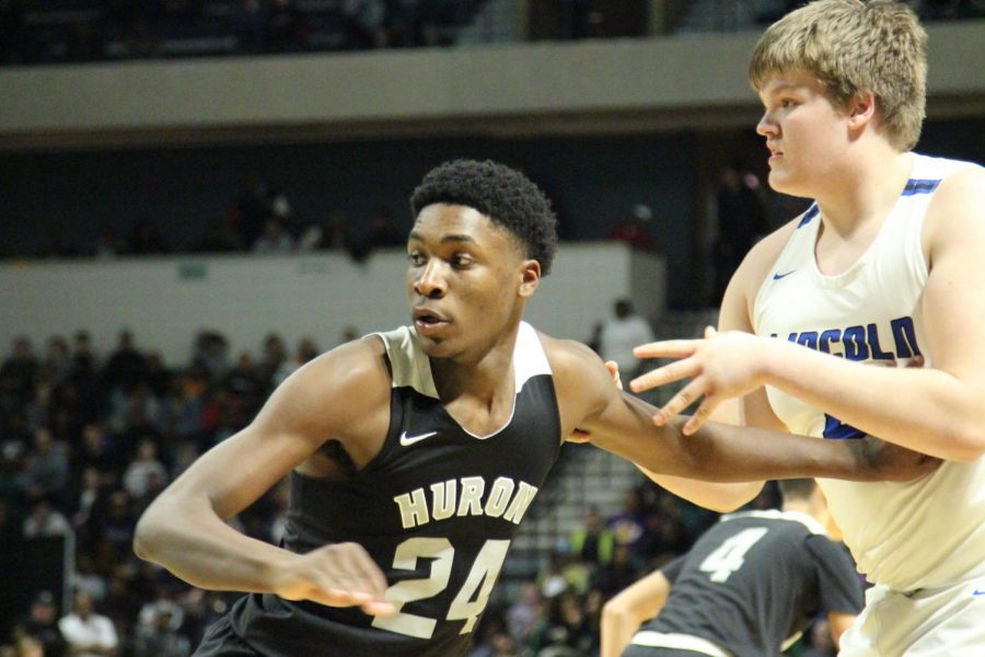 Senior Kingsley Perkins(24) setting up against a Lincoln player.