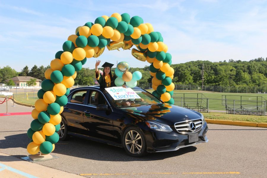 The Emerys 2019-2020 editor-in-chief Julie Heng drives through the balloon arch after passing the red carpet. 