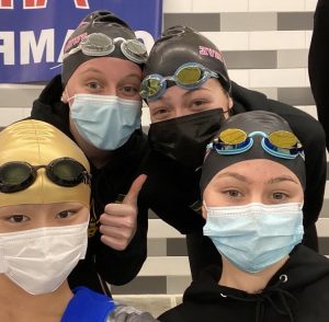 Min Xu, Annaliese Streeter, Kathryn Hemmila, and Zannah Baker pose for a selfie during the womens swim and dive states meet.