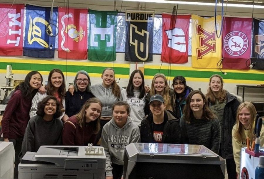 During pre-coronacation, the 2020 members of WISE huddle together for a picture in Hurons engineering laboratory. I loved going to the engineering room after school and doing fun things with other girls that were interested in the same stuff I was, President of WISE Catie Hart said.
