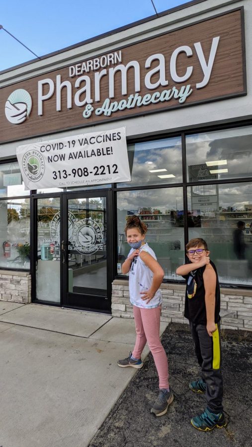 Luke (8) and Sydney (10) showing off their bandaids outside the pharmacy after getting vaccinated.