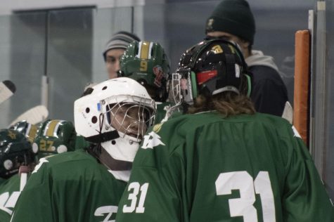 Senior goaltender Minseok Kim (left) and freshman goaltender Nate Bowman (right) converse during a timeout in the second period.