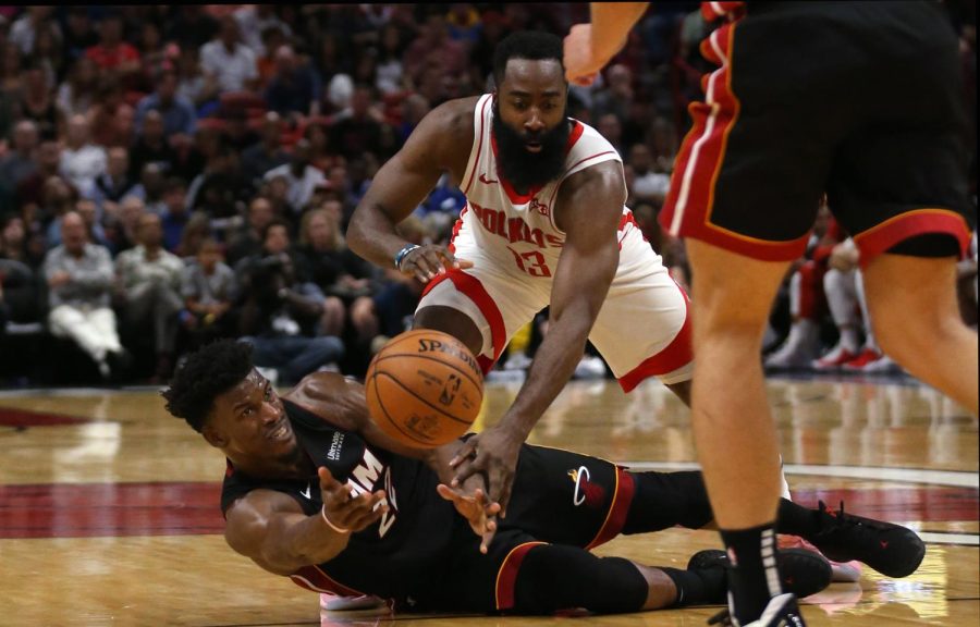 Miami Heat forward Jimmy Butler (22) passes the ball to Meyers Leonard (0) after stealing the ball to Houston Rockets guard James Harden (13) in the third quarter on Sunday, Nov. 3, 2019 at the AmericanAirlines Arena in Miami, Fla.