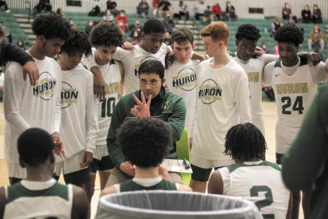 Huron varsity boys basketball coach Waleed Samaha speaks to his team during a timeout in the midst of a 63-45 victory against Bedford on Tuesday in the Dome.