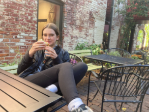  Audrey Hargett sitting at Kerrytown Market with friends enjoying a sandwich.