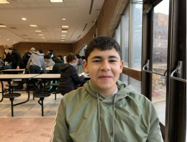 Hassan Hejazi enjoying his lunch in the Huron High School cafeteria.