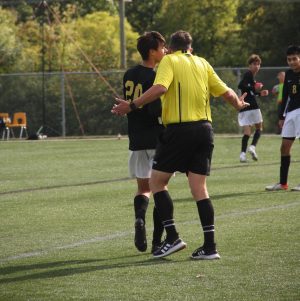 Senior midfielder Tim Baker argues with a referee about a call.