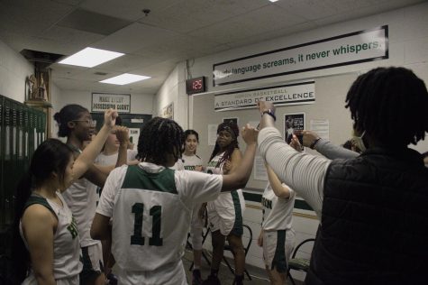 The team pumps themselves up in the locker room before the game.