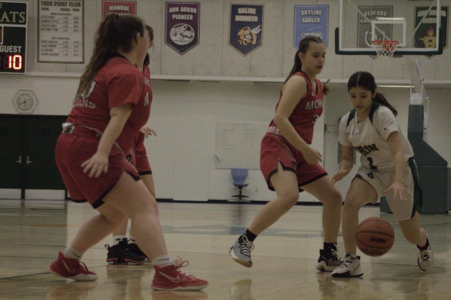 Sophomore Nancy Romero-Esquivel runs past defenders at the JV Girls basketball game on Jan. 10. The team lost 31-38 to Monroe.