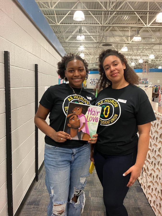 Seniors Zaria Dunas and Taylor Porter posing with one of the books that they read. As well as reading, to the students, the club played games, drew, and spent time with the Logan students. I feel like were very close like a family, junior Joiya Keith said. We get work done.