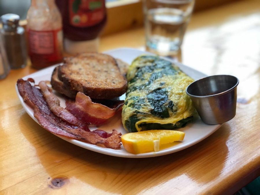 The+Vibrant+Veggie+Omelet+comes+with+a+side+of+bacon%2C+multi-grain+toast%2C+and+raspberry+jam.+