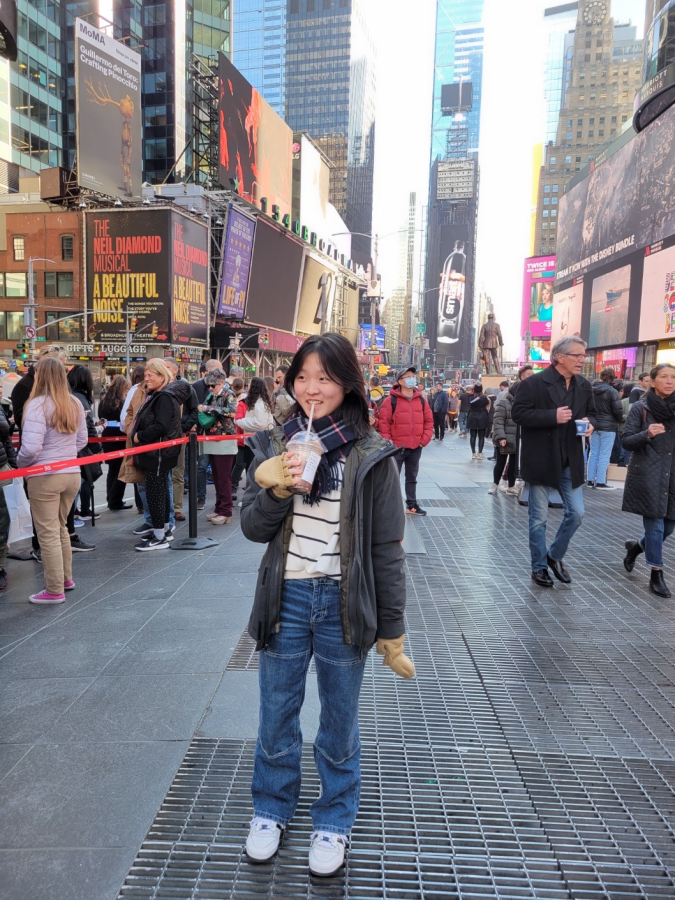 Lee posing for a picture in Times Square.