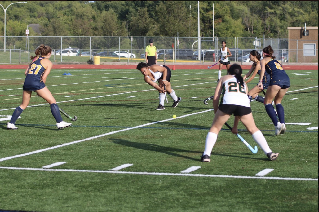 Junior Taylor Porter passes the ball to sophomore Grace Henley in the Huron defensive end.
