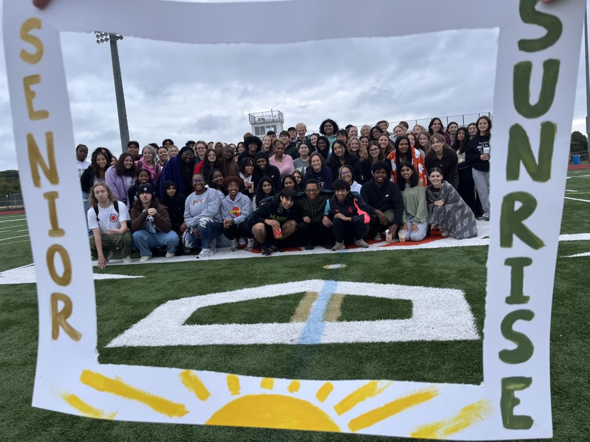 The seniors take a group photo with the “Senior Sunrise” picture frame decoration. Senior Sunrise was delayed to Tuesday, Sept. 12 due to the school being closed from power outages.