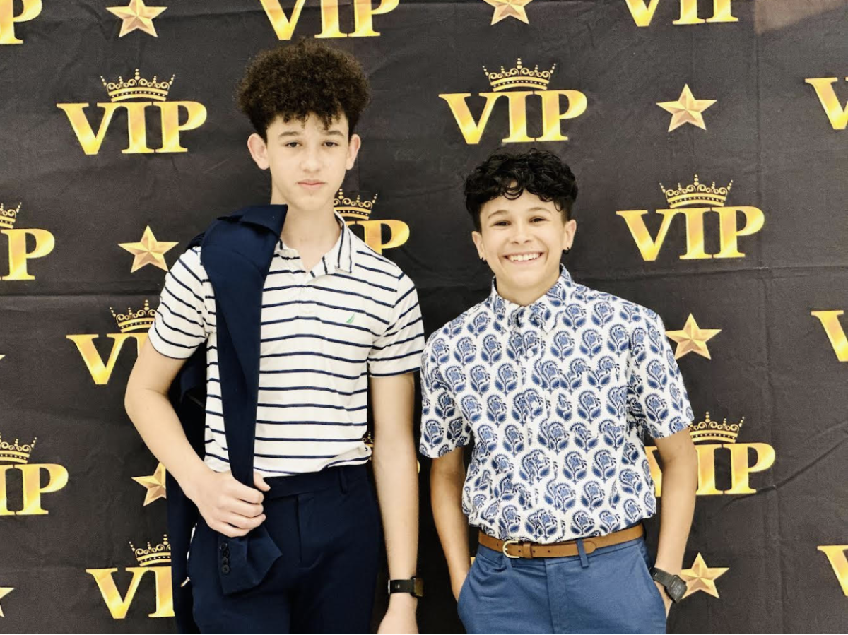 Deam (left) and his friend Selah Ostfeld-Hernandez (right) taking a picture during their 8th grade graduation celebration at Scarlett middle school. Photo courtesy of Deam.