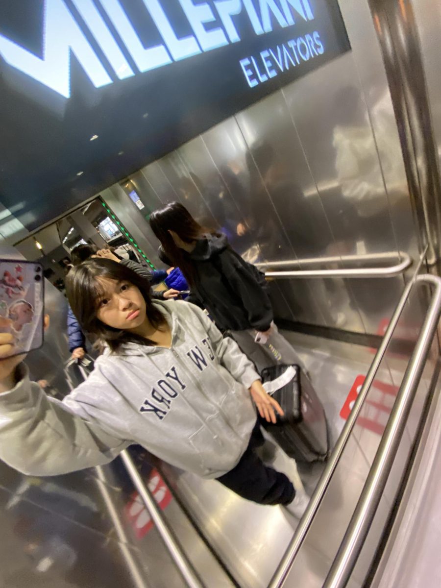 Chelsea taking an elevator selfie