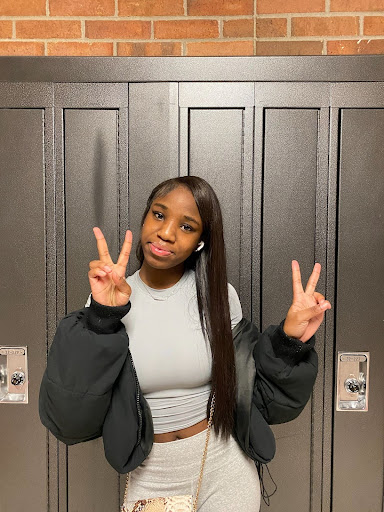 Conde puts up peace signs in the Huron hallway. Photo courtesy of Conde. 