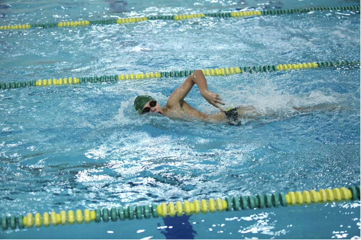 Senior Victor Heskia swimming at a meet at Huron. Heskia looks too clear his mind when he swims. 