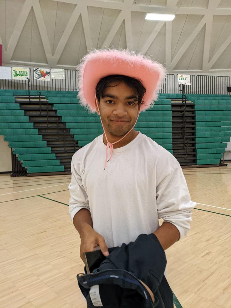 Alam smiles in the Huron gym with a cowboy hat. Photo courtesy of Alam. 