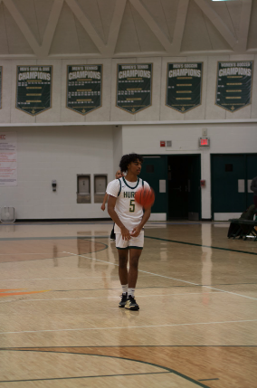 Senior Evan Tinkham on the court playing for varsity basketball. Photo courtesy of Tinkham.