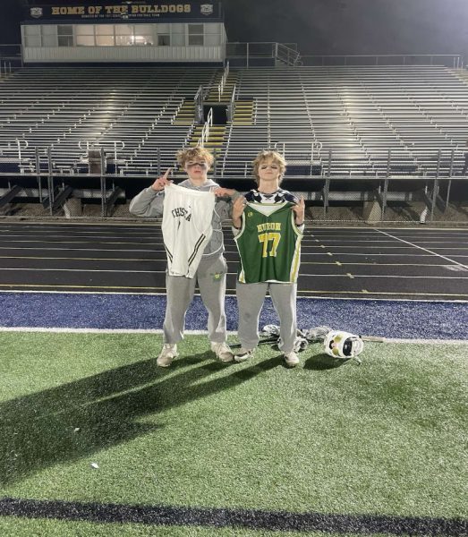 Senior Preston Hermansen swaps jerseys with his old teammate after an upset win in lacrosse against Chelsea. 	Photo courtesy of Hermansen
