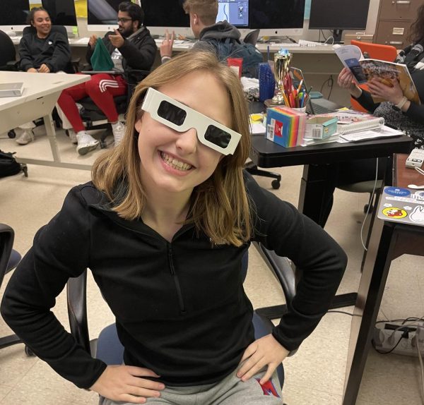 Senior Anna Esper wearing the eclipse glasses.