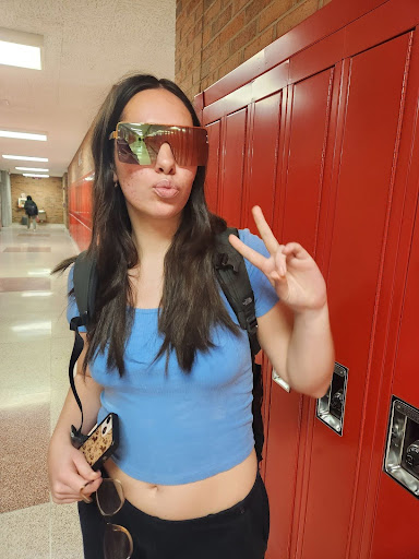 Adelaide Romero wearing a friend’s pair of sunglasses outside of her English class. Photo courtesy of Romero