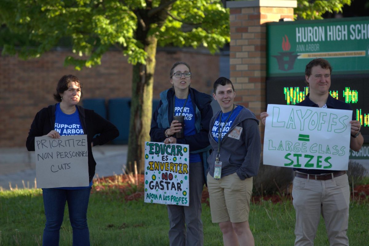 Teachers stand outside of Huron on May 8 to protest staff layoffs and encourage community members to come to Board meetings. 