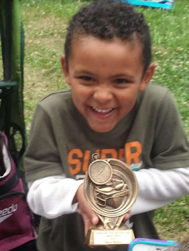Thayer, as a child, winning a trophy. Photo courtesy of Wallace
