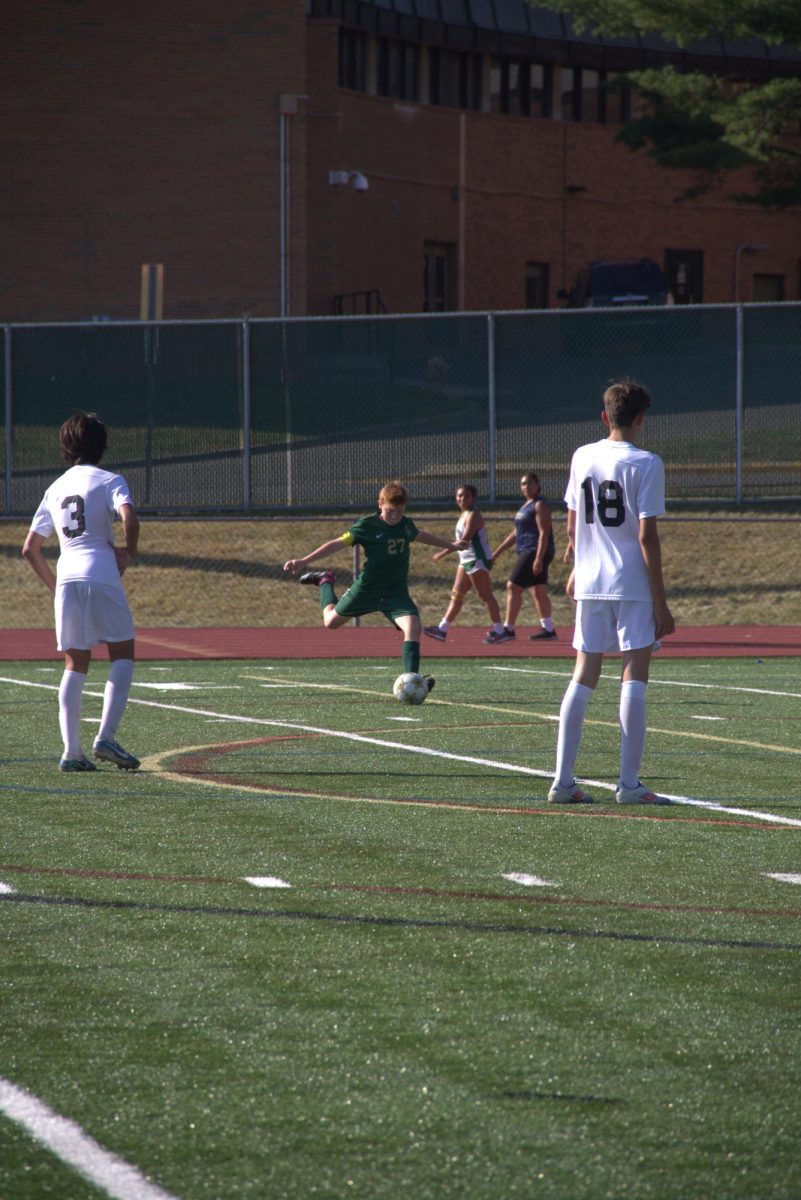 Freshmen soccer coach Oliver Hammond winds a kick to the Skyline net