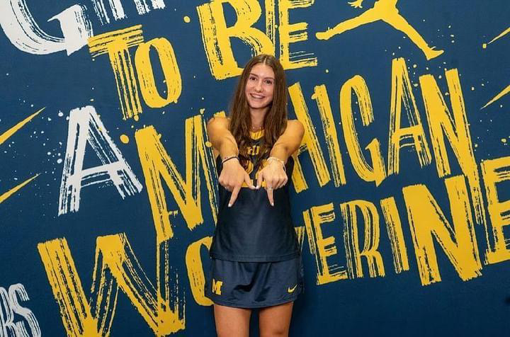 Huntzicker posing in front of a University of Michigan board. Photo in courtesy of Huntzicker