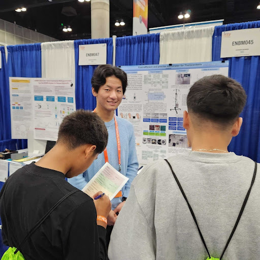 Qian Li with his manometer and poster board at the International Science and Engineering Fair. Photo in courtesy of Qian Li.