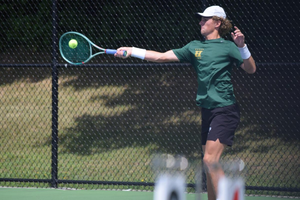 Senior Warren Gunnar swinging at the ball to return it. Photo courtesy of Elizabeth Williamson.