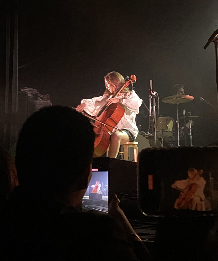 Laufey playing the cello at her concert, adding in core elements of classical music.