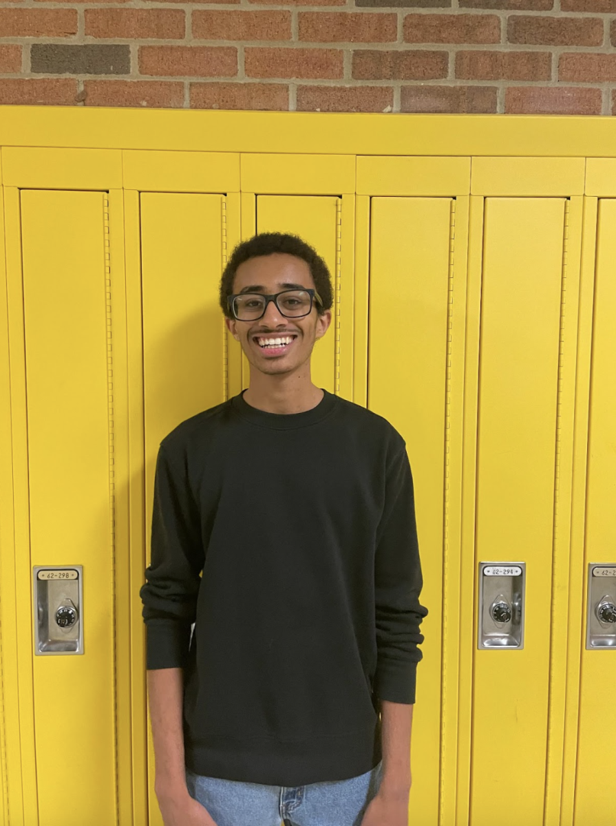 Junior Mike Yimer posing for a photo in the 6200 hallway at Huron High School. 