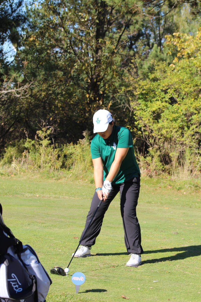 Junior Jennifer Tang, a lefty, setting up for the ball with her right-handed club. Most tools and resources are designed for right handed people. According to a study by the National Library of Medicine, only 10 percent of people are left handed. Photo courtesy of Patrick Kelly