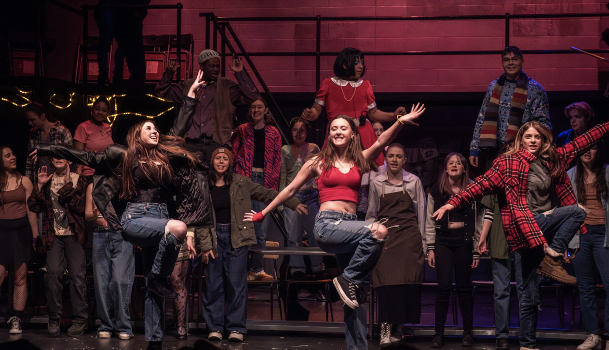 In the show, members of the Dancing Ensemble jump in joy in a cafe together. 