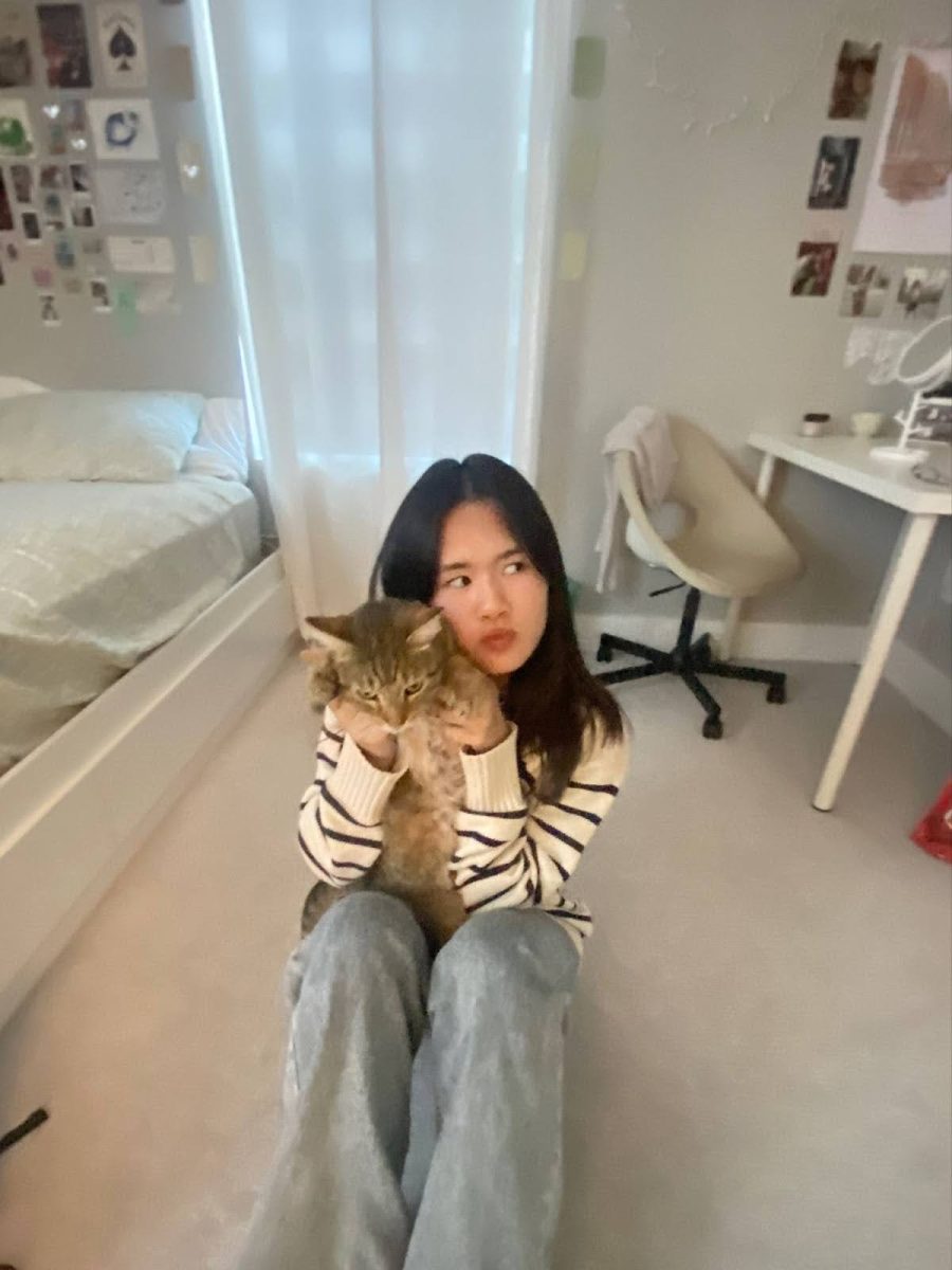 Pham posing with her cat Yuki. Courtesy of Sophia Pham. 
