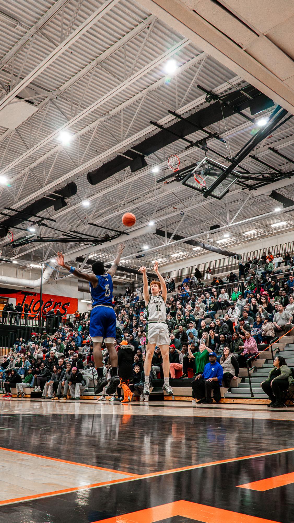 Keefer attempts a three-point shot to tie the game up early in the first quarter of the game.  Keefer made this three-pointer and went on to score 11 total points.