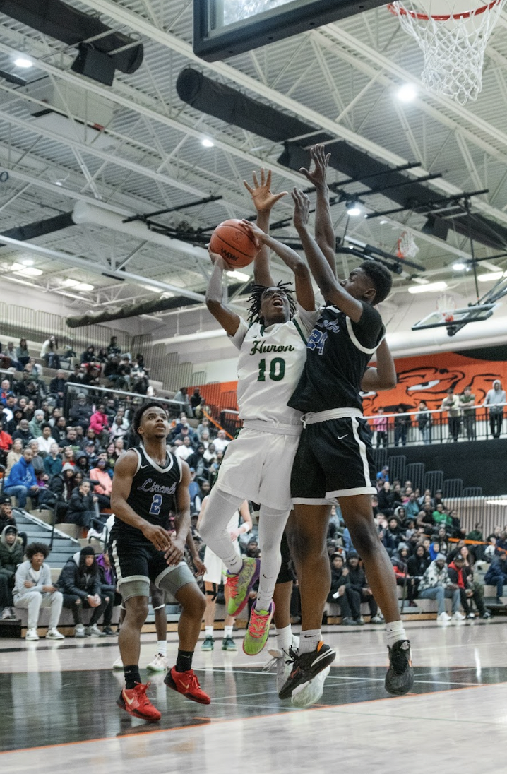 Junior Kinley Pool highly contested pushing through the defense to make a layup