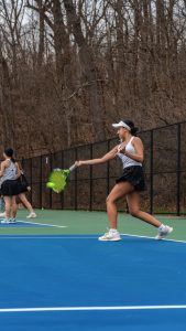Jadhav making contact with the ball during a forehand during practice.
