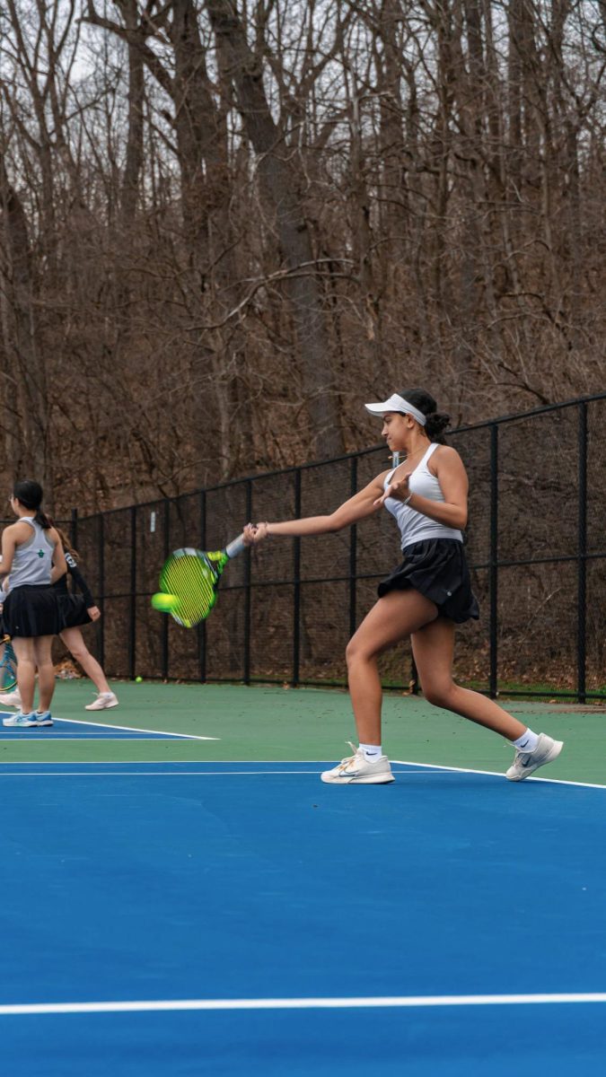 Jadhav making contact with the ball during a forehand during practice.