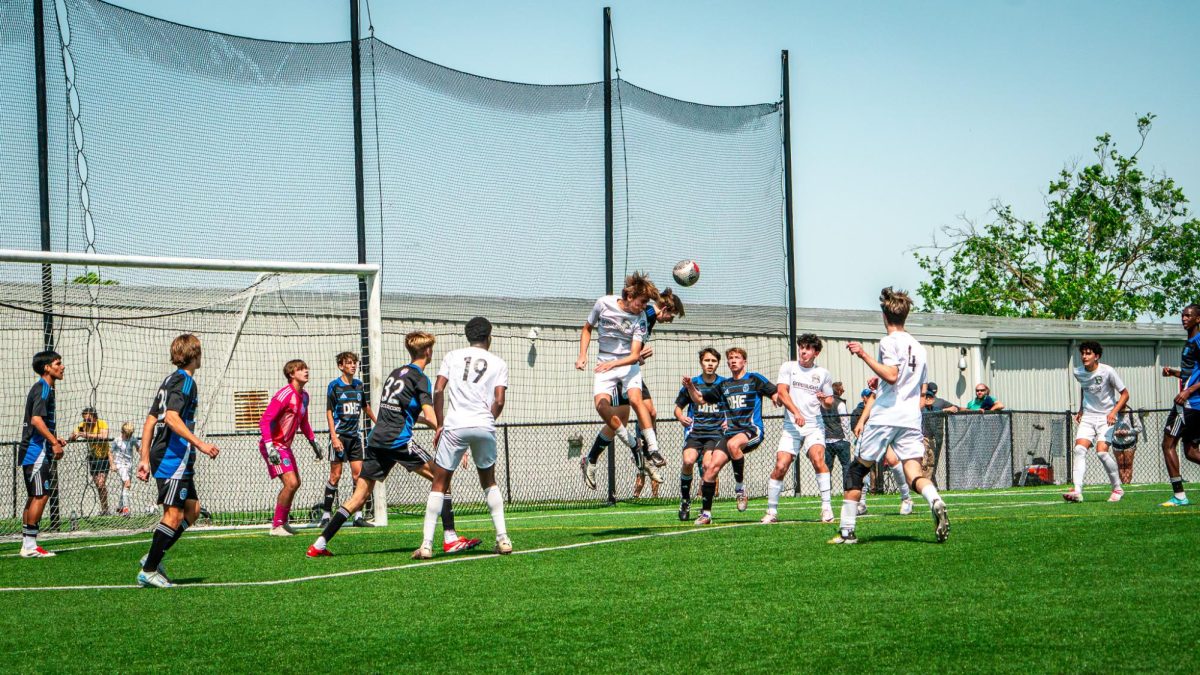 Junior Jules Heskia contests a 50-50 header in a corner kick.