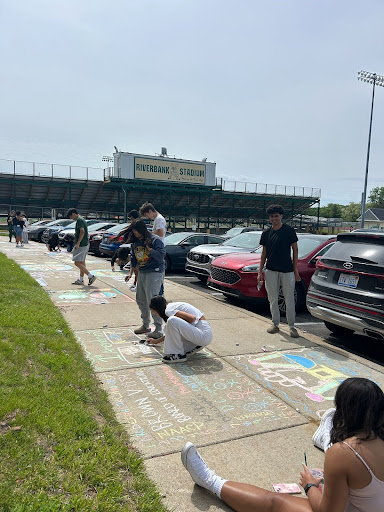 AP Government students working on their final project using chalk. 