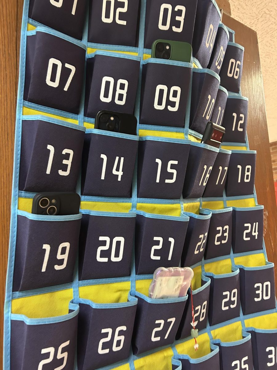 Every classroom has cell phone pockets for students to drop their phones in before the start of class.